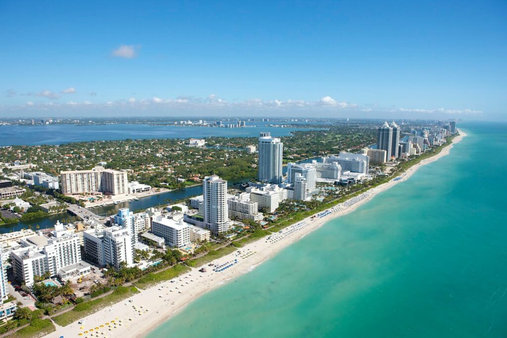 aerial view of city buildings near the ocean front during daytime