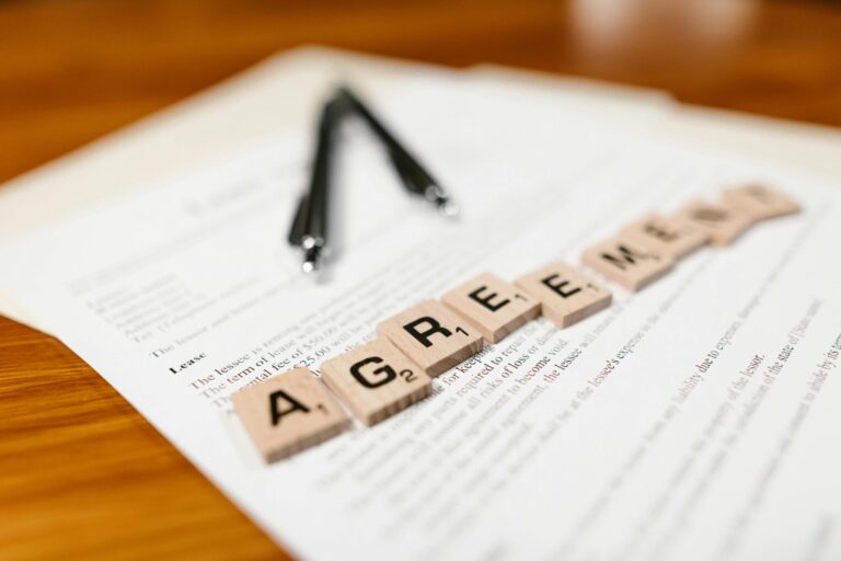 brown wooden scrabble tiles on top of a paper