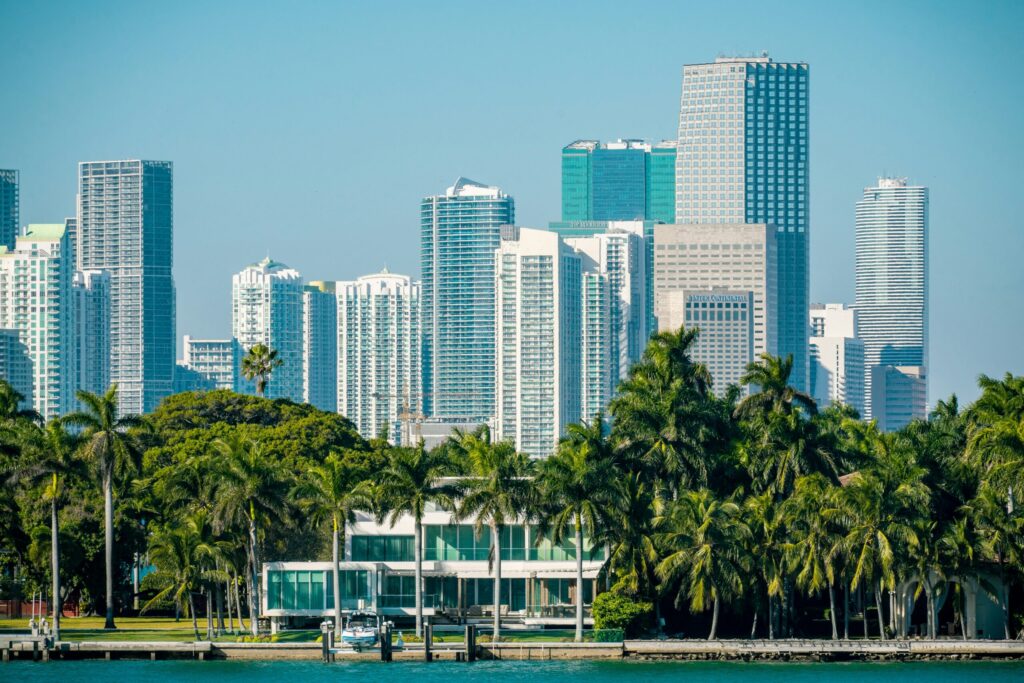Green trees near city buildings during daytime