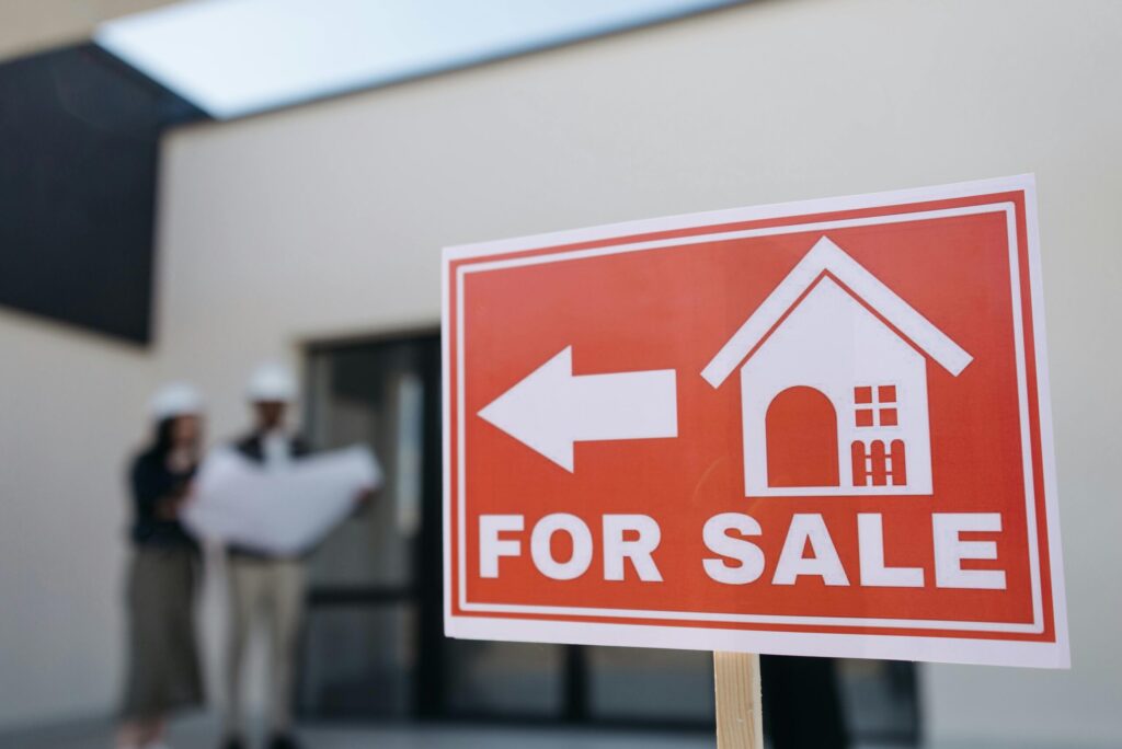 a red home for sale sign