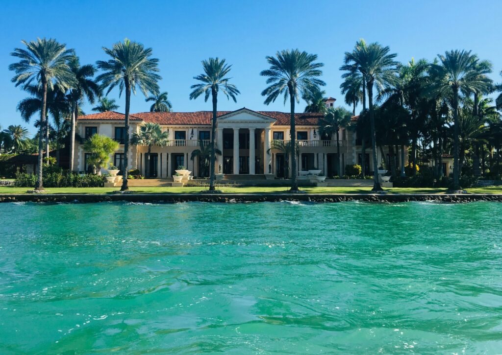 brown and white concrete house near a body of water
