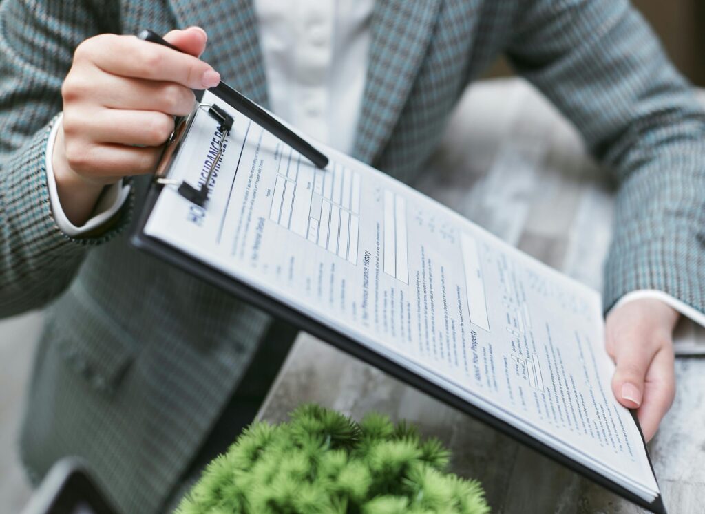 a person holding an insurance paperwork